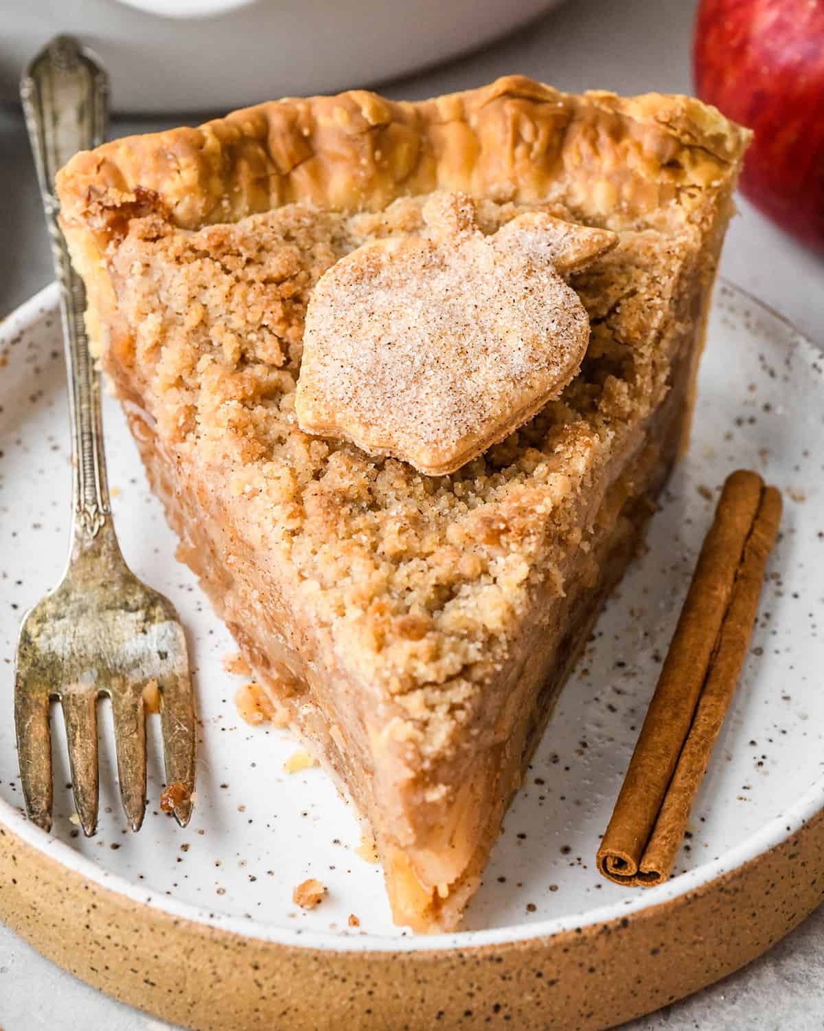a slice of apple crumb pie on a plate