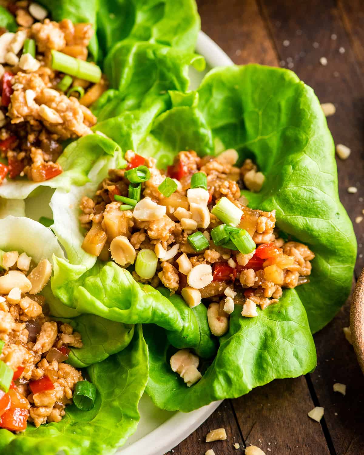 up close overhead view of an Asian chicken lettuce wrap on a plate