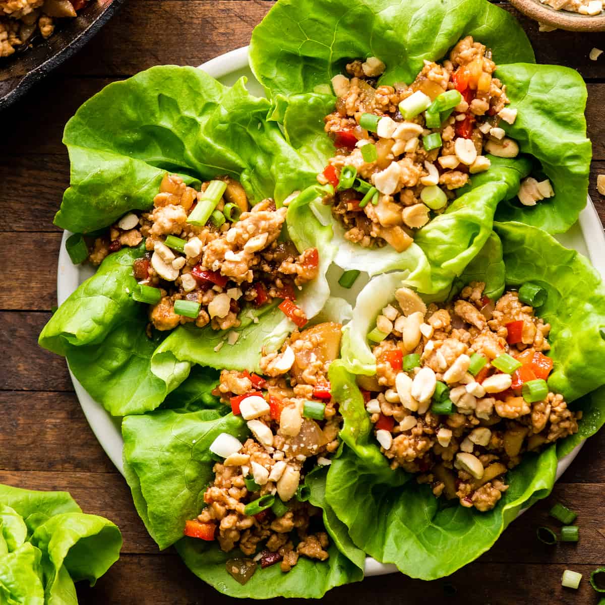 overhead view of four chicken lettuce wraps on a plate