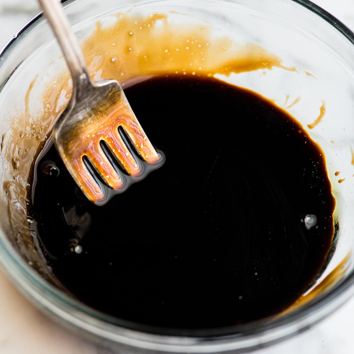 balsamic glaze in a bowl with a fork