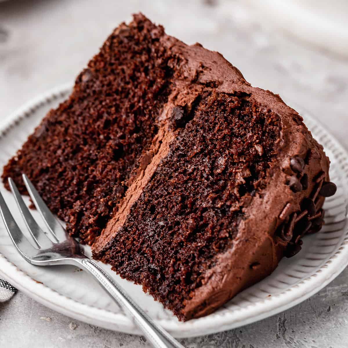a slice of chocolate cake on a plate with a fork