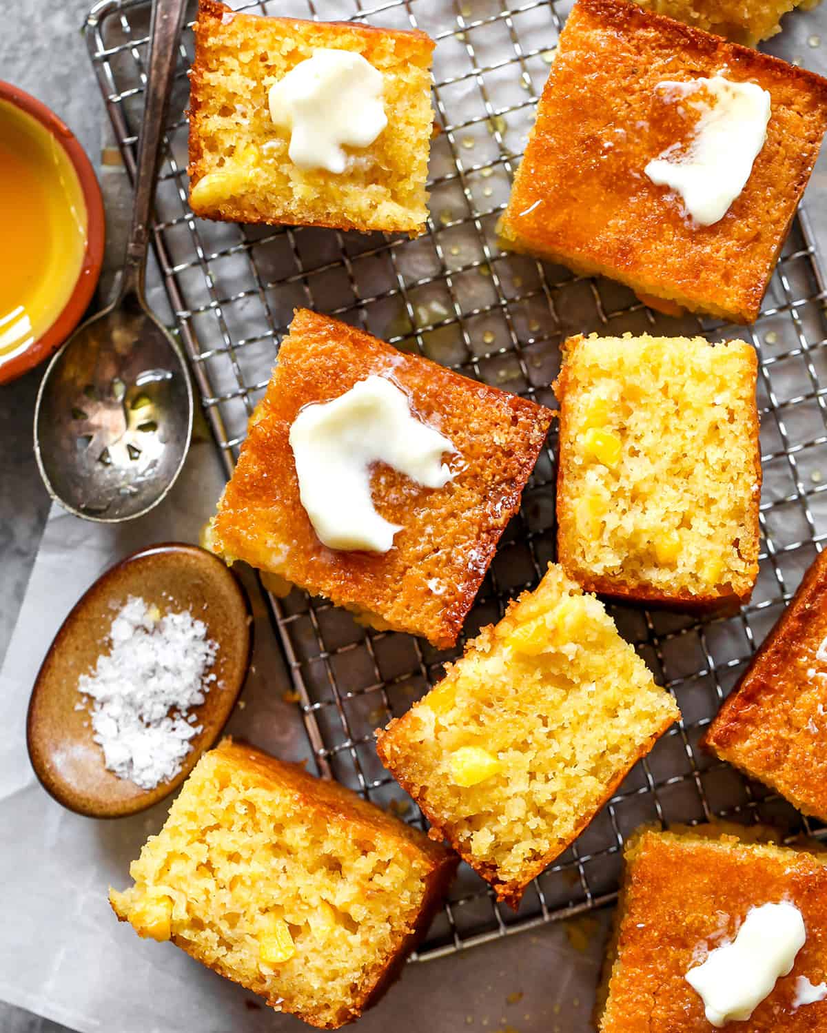 overhead view of the best homemade cornbread cut into squares with butter