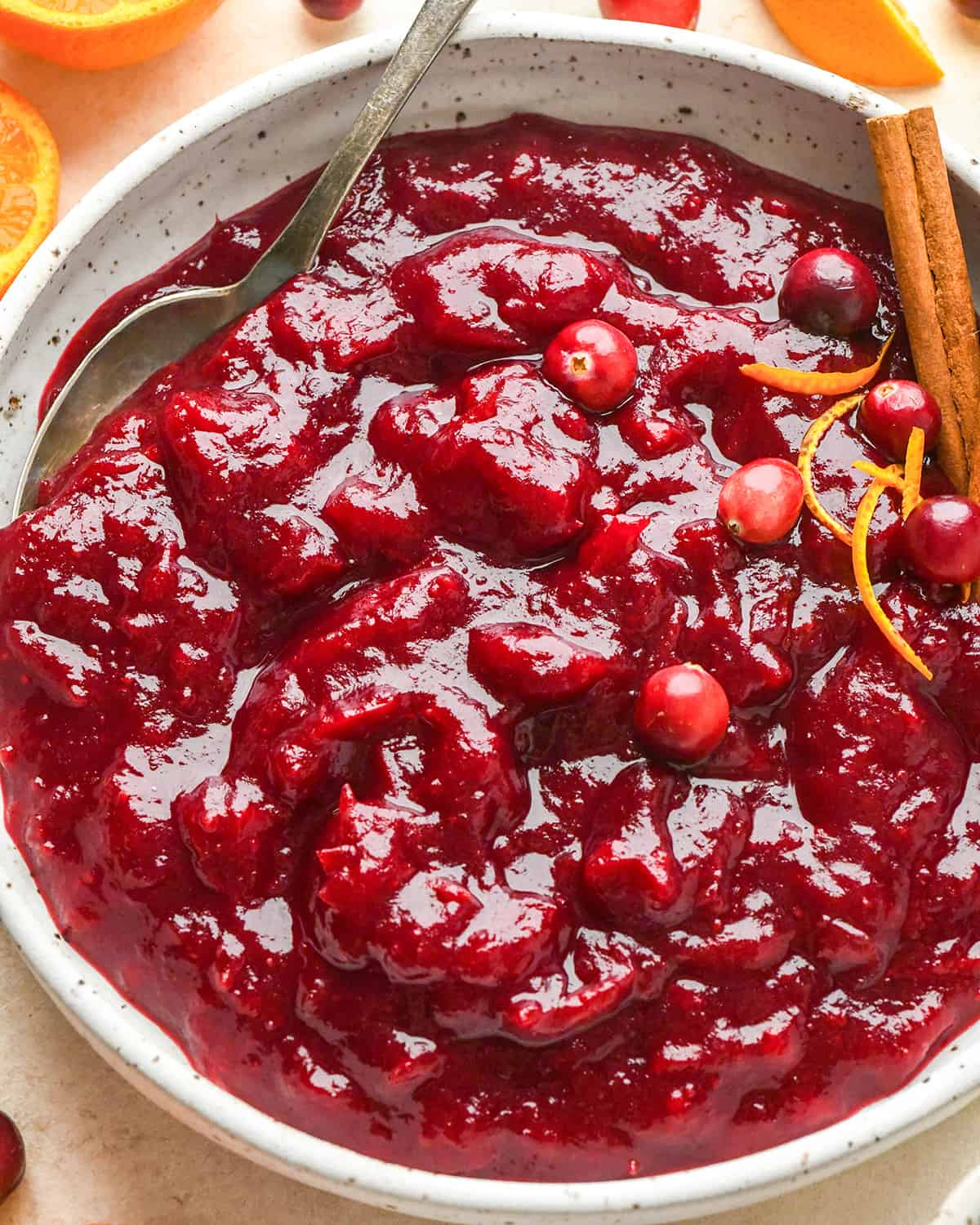 a bowl of Homemade Cranberry Sauce with Orange Juice with a spoon