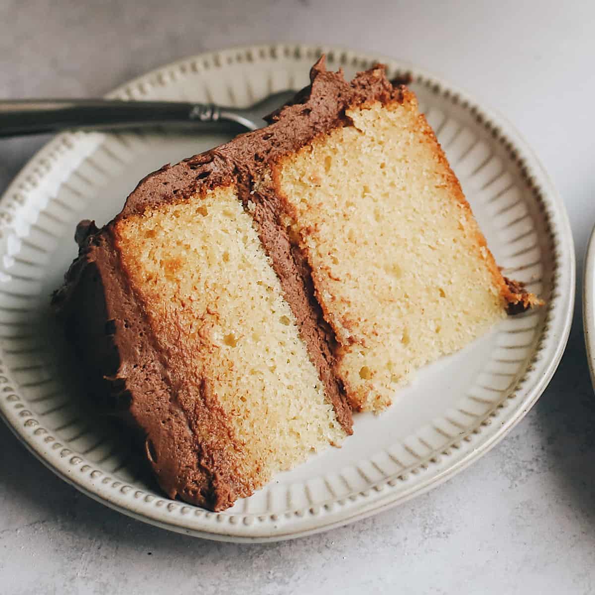 a slice of yellow cake on a plate