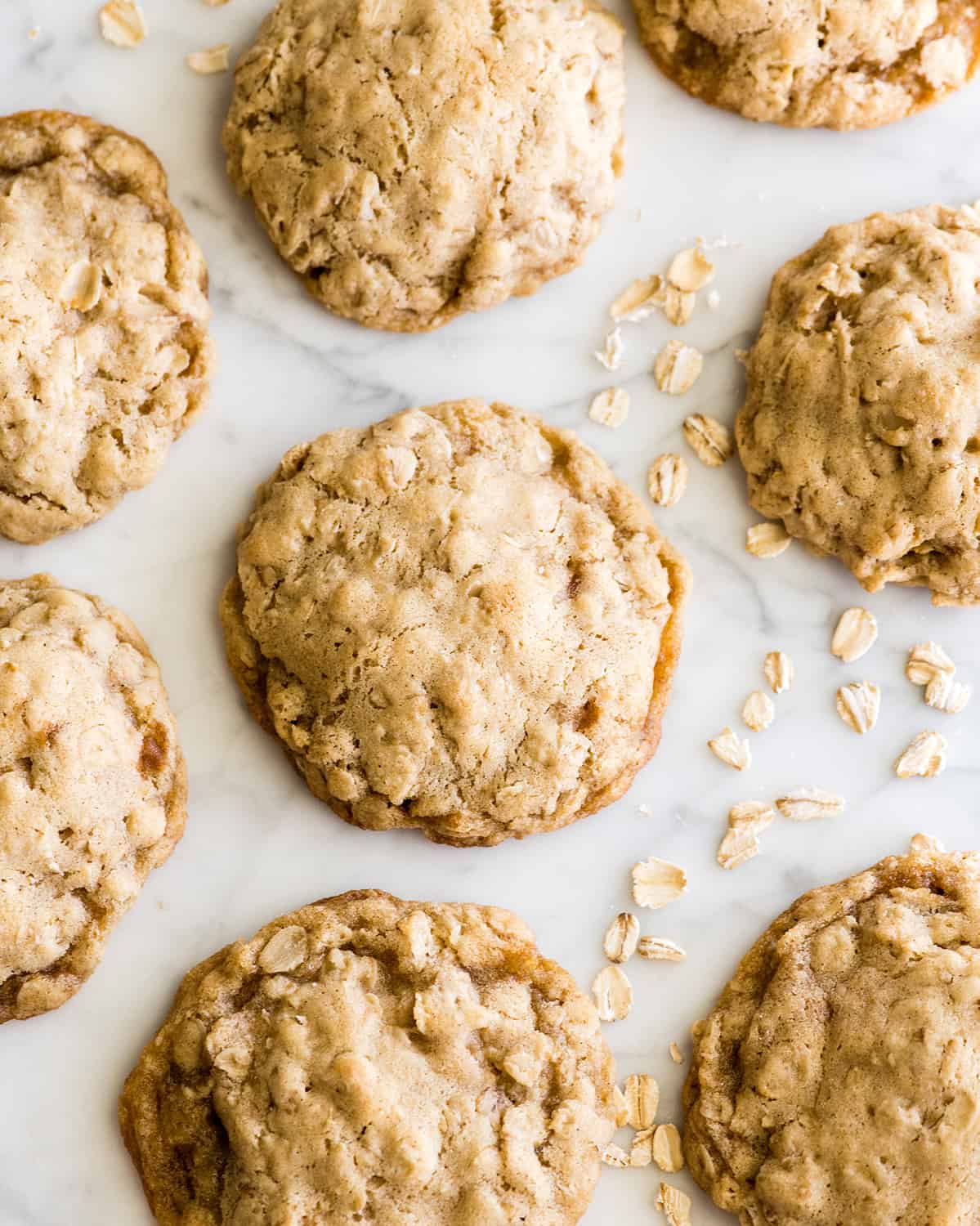 photo of seven oatmeal cookies on a white marble background