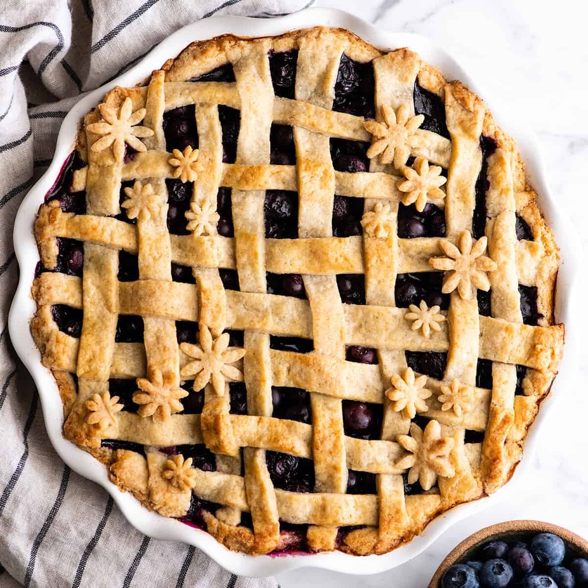 overhead view of a baked blueberry pie with a lattice crust