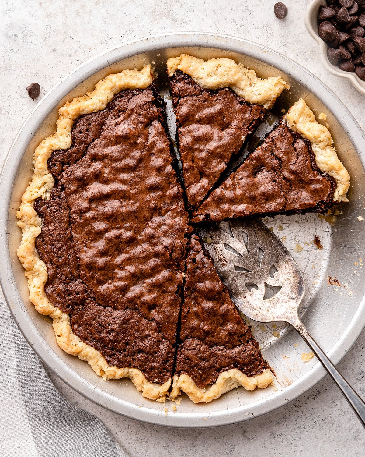 Brownie Pie in a pie dish with 3 pieces cut out