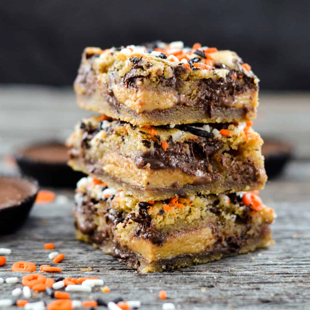 Front view of a stack of three candy cookie bars.