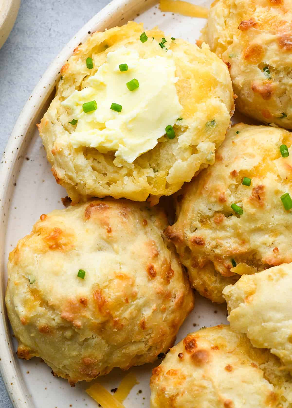 Cheese Biscuits on a plate with butter and chives