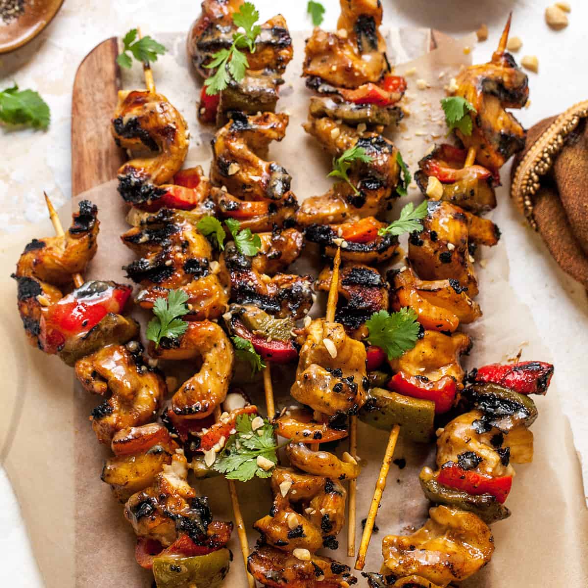 overhead view of chicken satay skewers on a serving plate