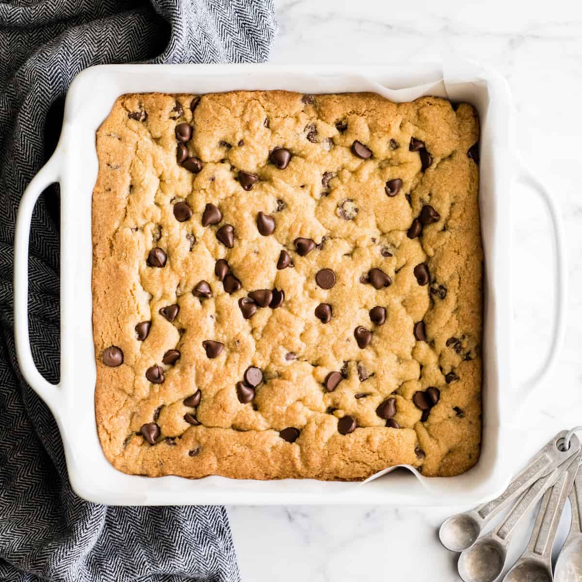 overhead view of chocolate chip cookie bars baked in a square dish