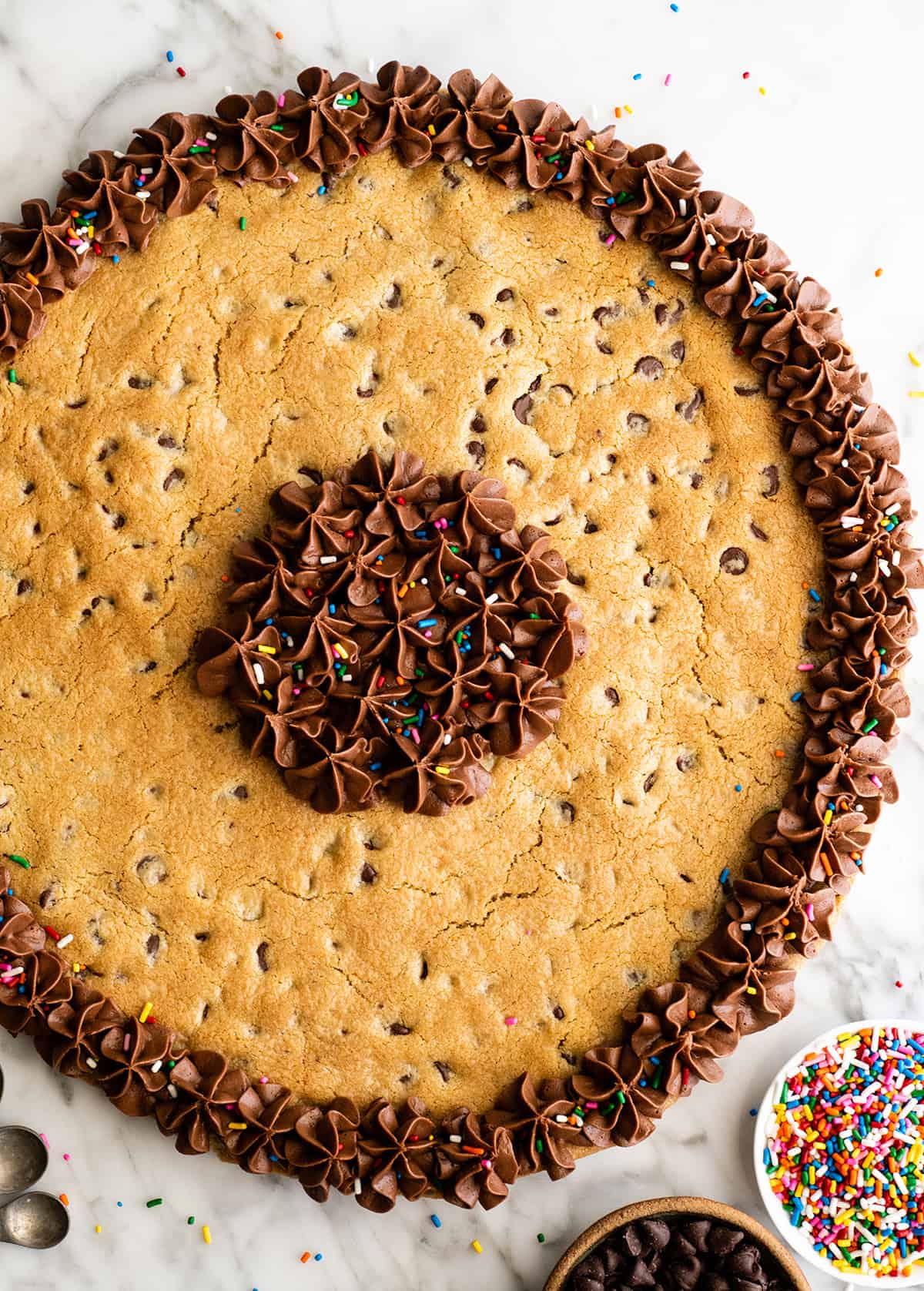 overhead view of a Chocolate Chip Cookie Cake with chocolate frosting