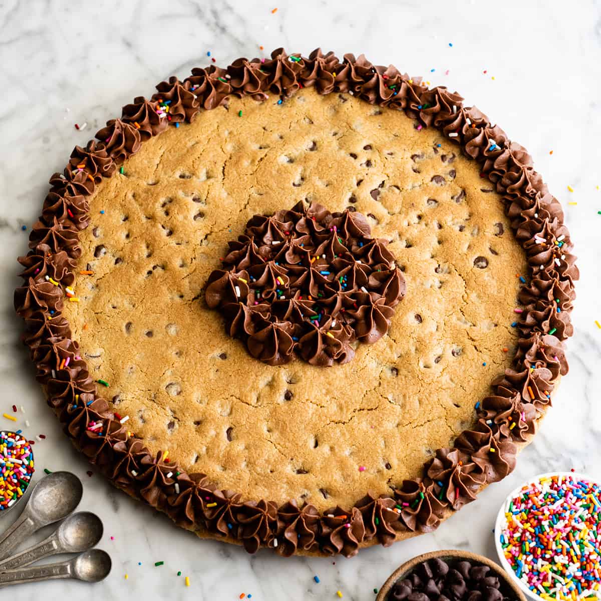 photo of a Chocolate Chip Cookie Cake decorated with chocolate frosting
