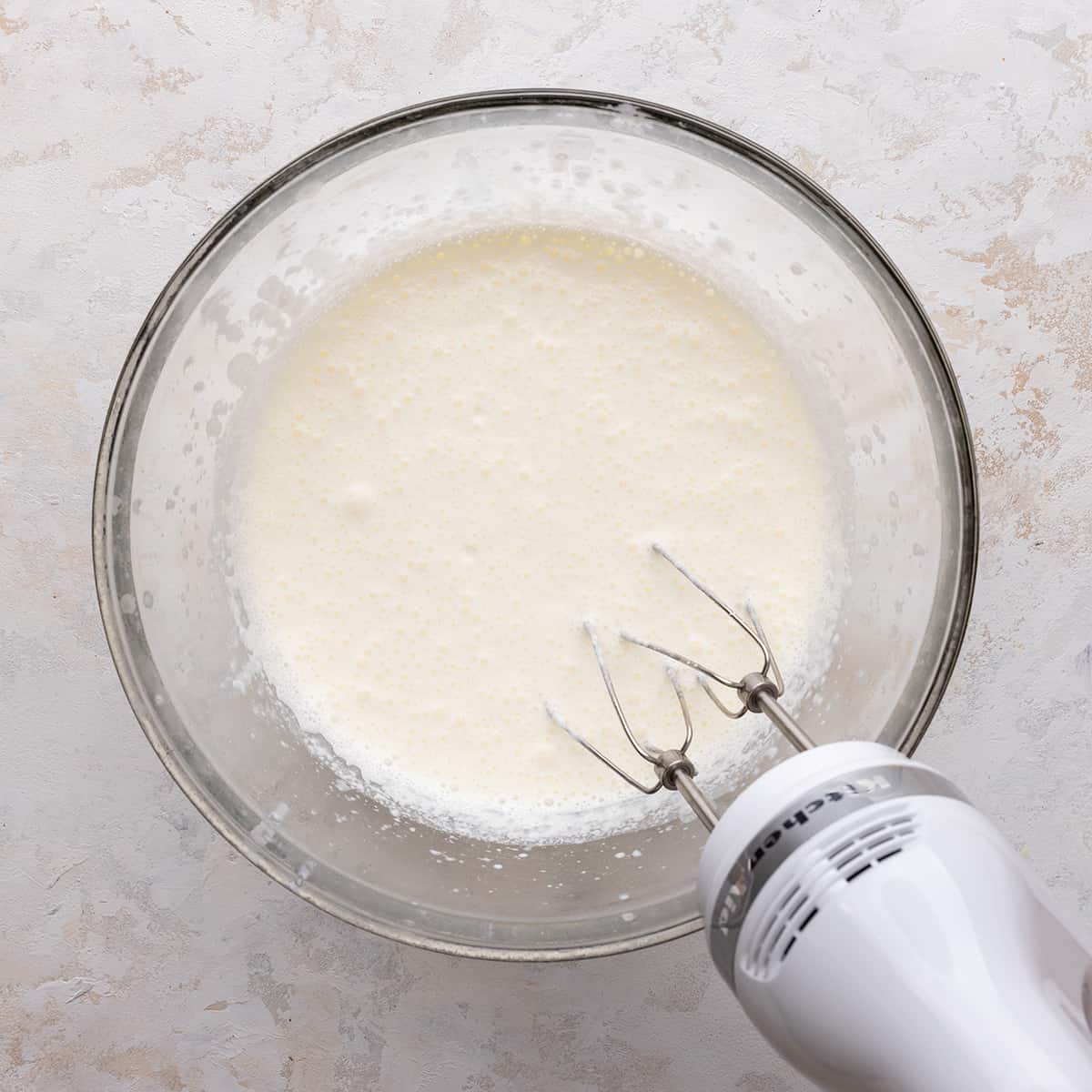 a mixer whipping heavy cream to make Chocolate Whipped Cream