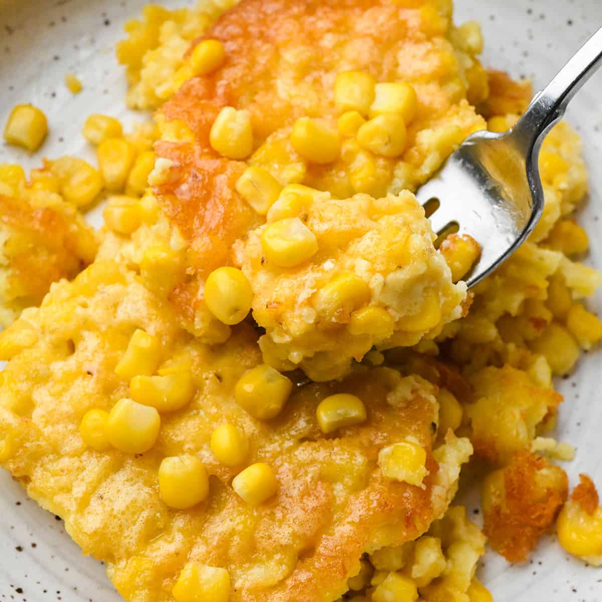 Corn Pudding on a plate with a fork