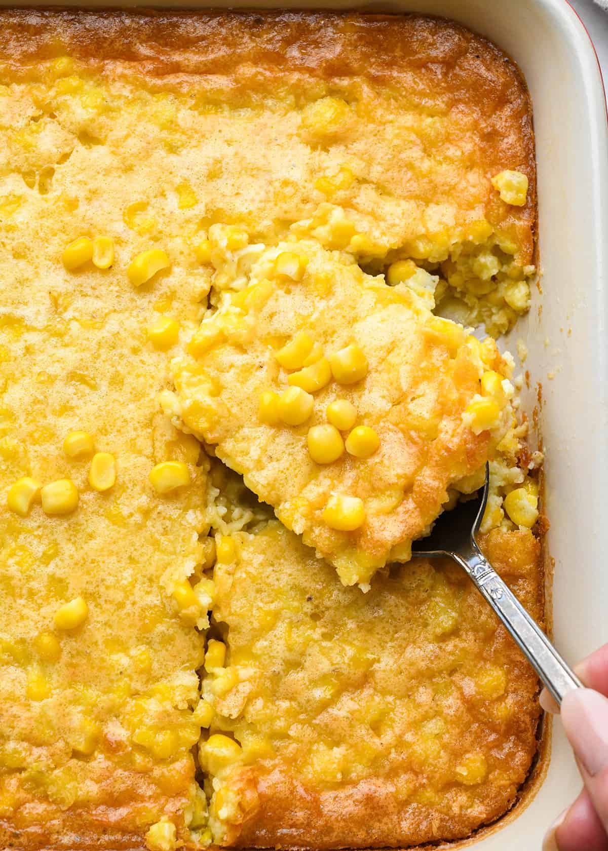 Corn Pudding in a baking dish - a piece being lifted out