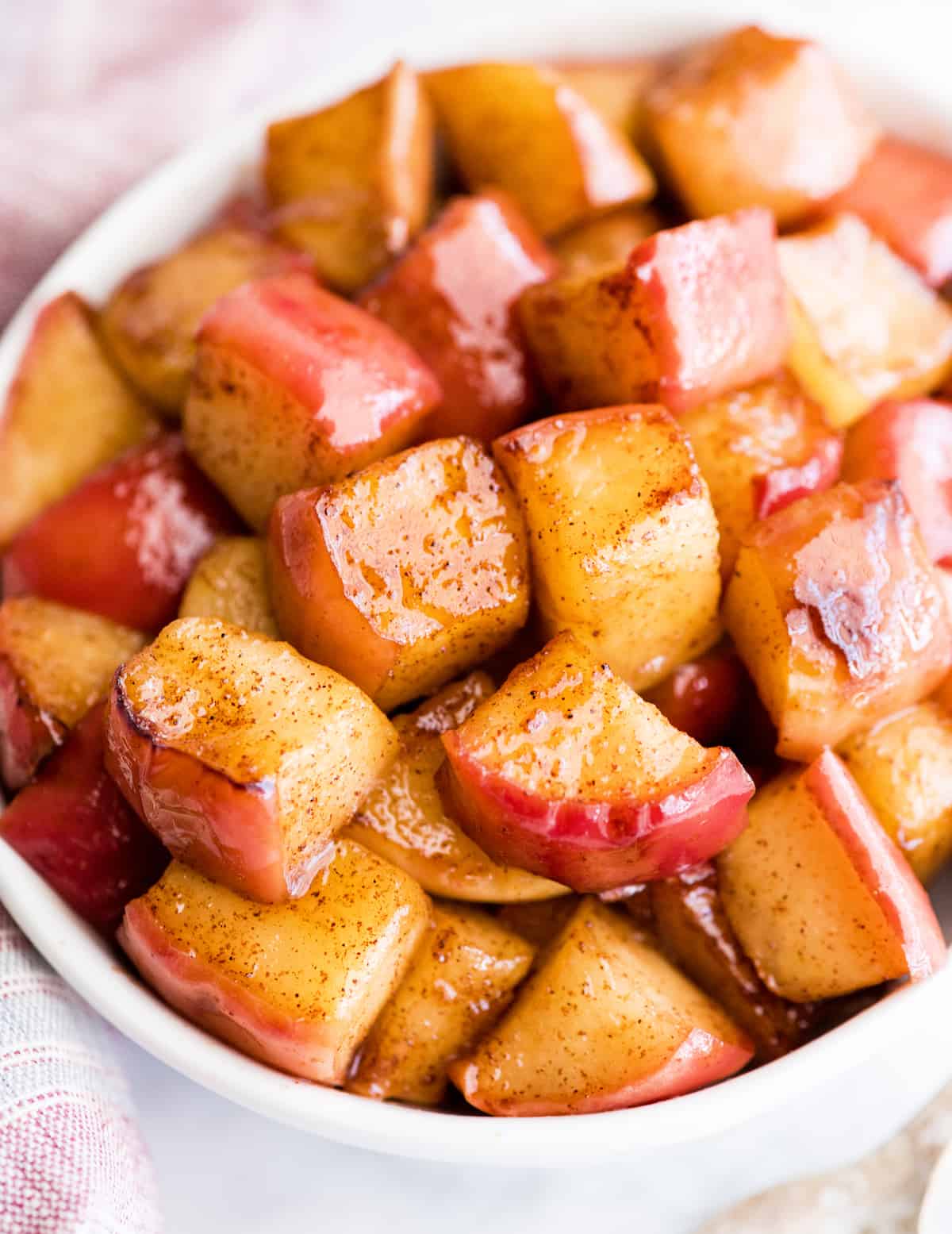 up close front view of cinnamon apples in a bowl
