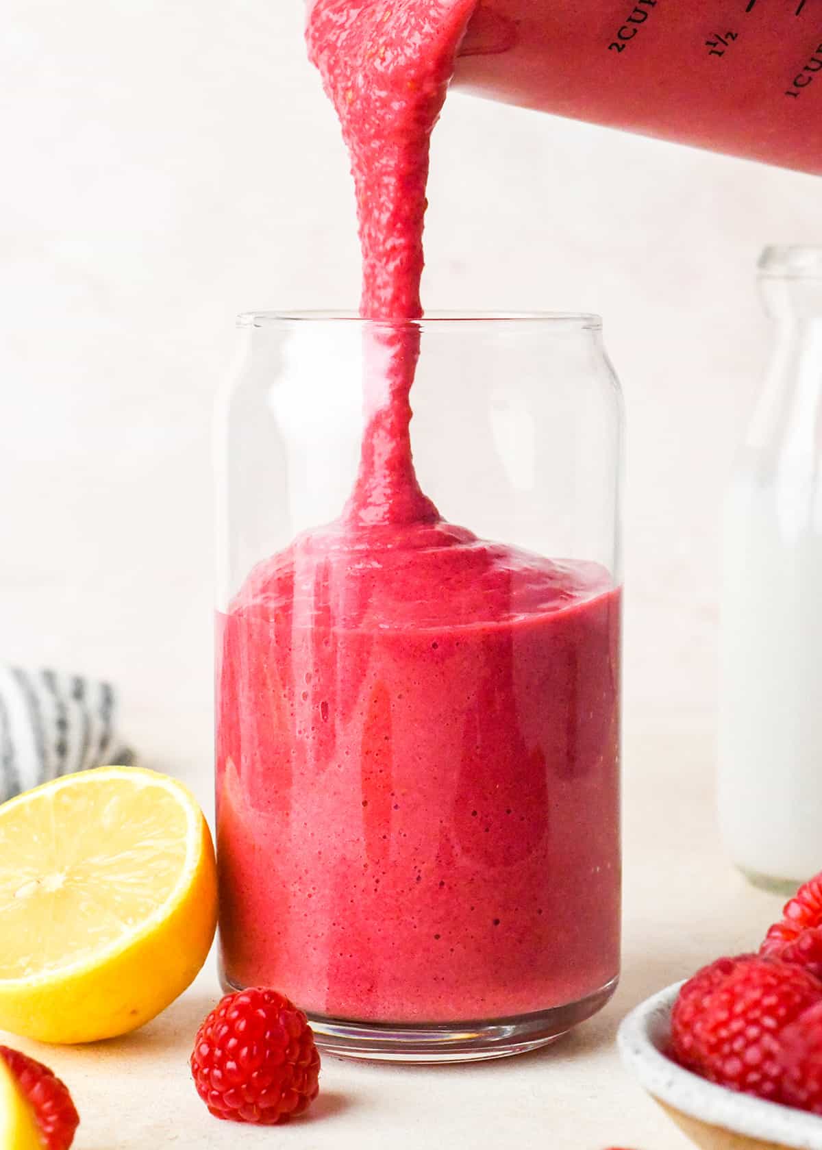 Raspberry Smoothie Recipe being poured into a glass 