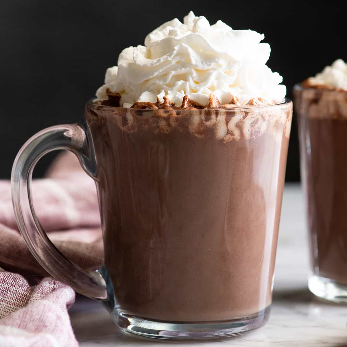 front view of a mug of homemade hot chocolate with whipped cream