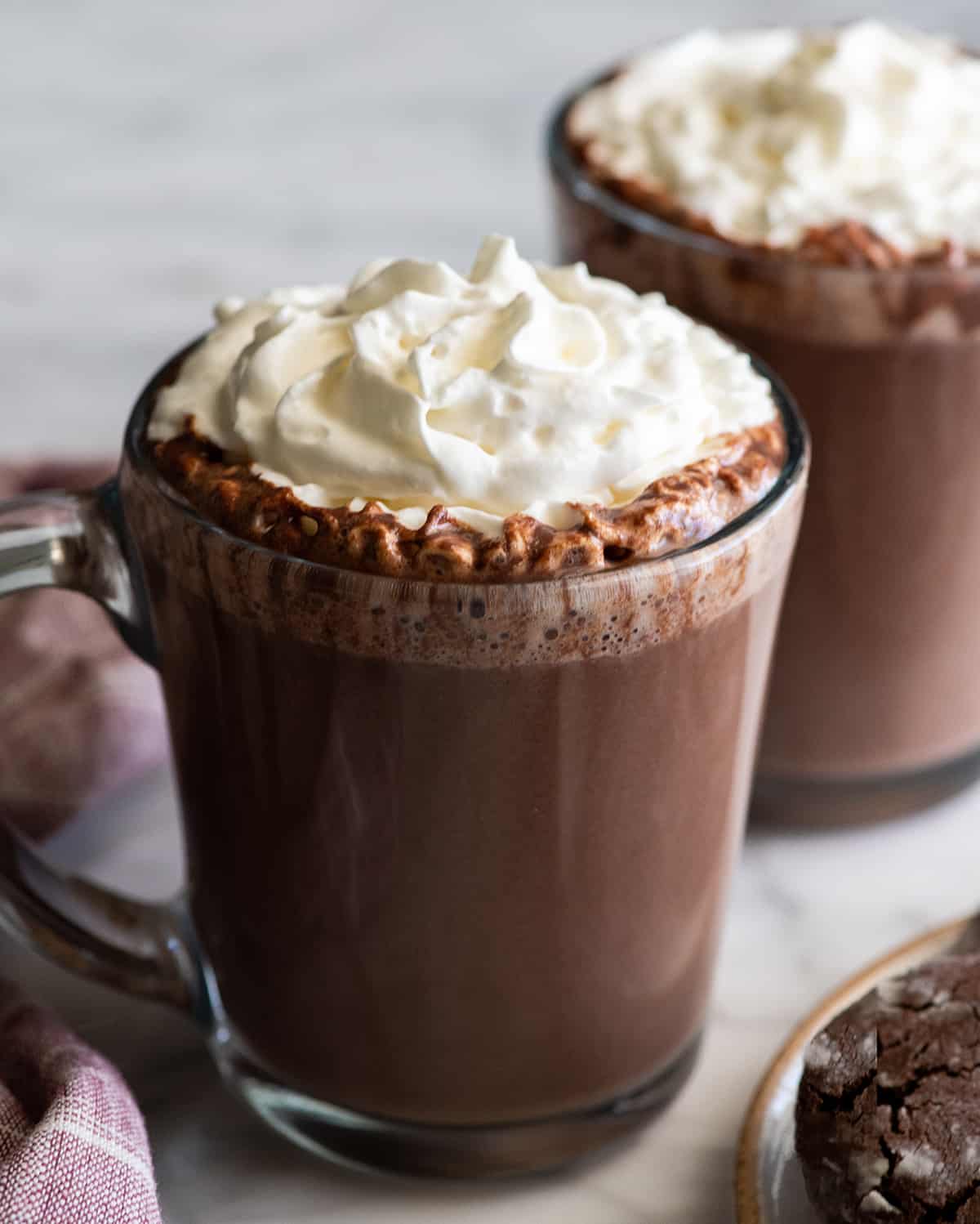 glass mug of homemade hot chocolate with whipped cream