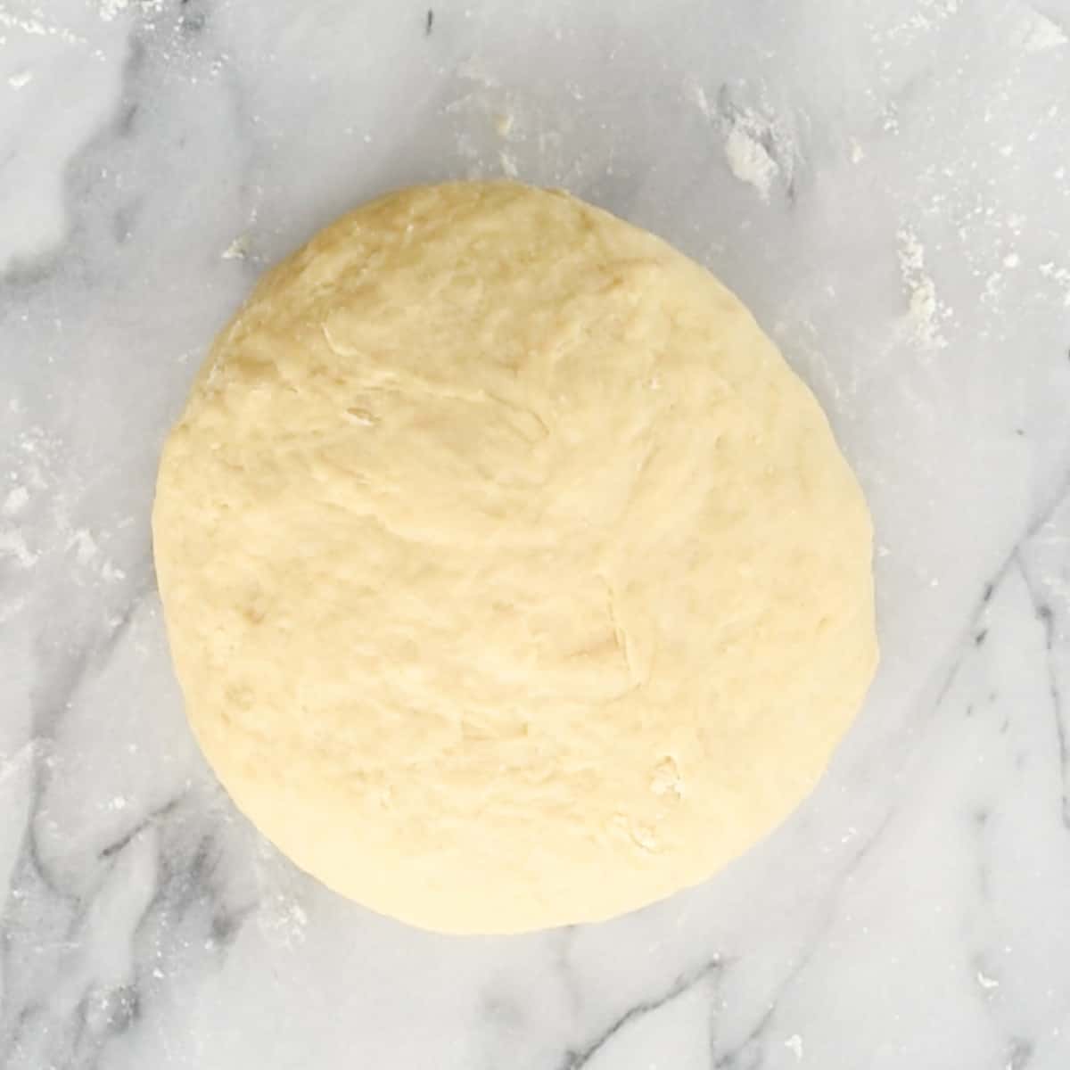 homemade dinner roll dough shaped into a ball