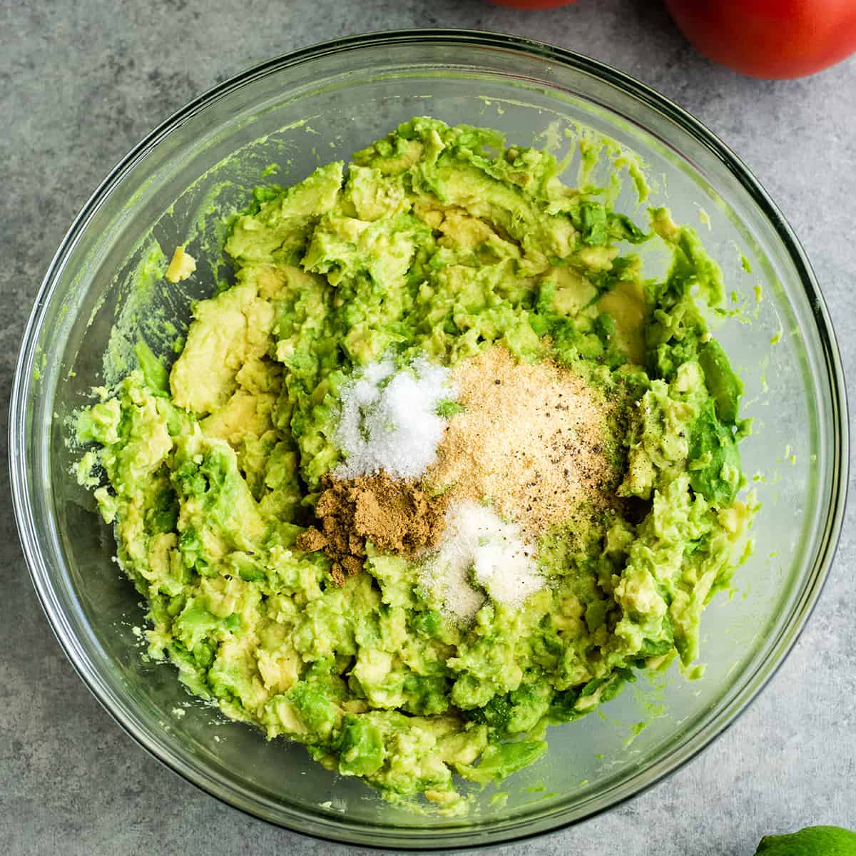 photo showing How to make Guacamole - adding spices and salt 
