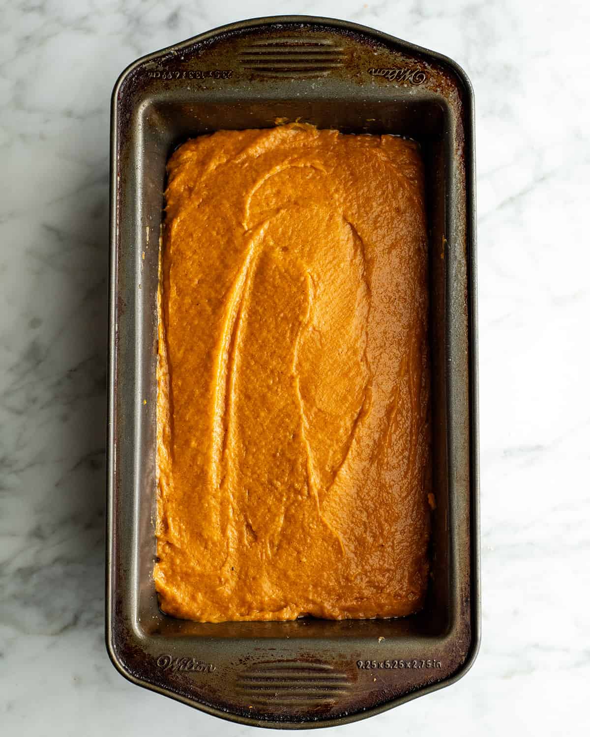 pumpkin bread batter in a baking pan before baking