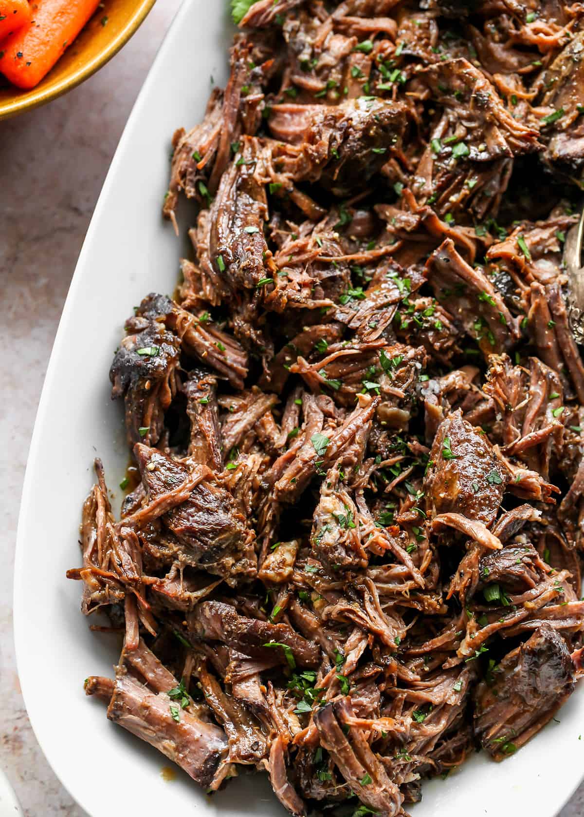 up close overhead view of a plate of shredded Balsamic Slow Cooker Pot Roast